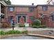 Two-story brick townhouse featuring well-maintained landscaping in a suburban setting at 3125 Colonial Way # H, Atlanta, GA 30341