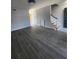 Bright, spacious living room featuring hardwood flooring, freshly painted walls, and staircase at 3125 Colonial Way # H, Atlanta, GA 30341