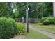 View of the community tennis court with green landscaping and walking path in the foreground at 3125 Colonial Way # H, Atlanta, GA 30341