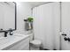 Bathroom featuring white cabinets, a shower curtain, and neutral accents at 1514 Park Grove Dr, Lawrenceville, GA 30046