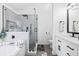 Modern bathroom with black hardware, glass shower, separate tub, and white cabinets at 1514 Park Grove Dr, Lawrenceville, GA 30046
