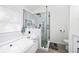 Bright bathroom with a large tub, glass shower, and modern fixtures at 1514 Park Grove Dr, Lawrenceville, GA 30046