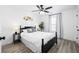 Bedroom with a large bed, bedside tables, neutral decor, and wood-look floors at 1514 Park Grove Dr, Lawrenceville, GA 30046