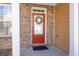 Close-up of a welcoming red front door with glass panels and a charming decorative wreath at 1514 Park Grove Dr, Lawrenceville, GA 30046