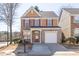 Two-story home with brick, siding, red shutters, and a one-car garage, set on a well-maintained lawn at 1514 Park Grove Dr, Lawrenceville, GA 30046