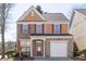 Charming two-story home featuring brick and siding, attached garage, and a welcoming front porch at 1514 Park Grove Dr, Lawrenceville, GA 30046
