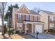 Two-story home with brick accents, siding, red shutters, a garage, and a neatly landscaped front yard at 1514 Park Grove Dr, Lawrenceville, GA 30046