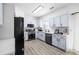 Bright kitchen featuring stainless steel appliances, light blue cabinets, and light hardwood flooring at 1514 Park Grove Dr, Lawrenceville, GA 30046