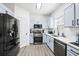 Bright kitchen featuring stainless steel appliances, light blue cabinets, and light hardwood flooring at 1514 Park Grove Dr, Lawrenceville, GA 30046