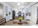 Stylish eat-in kitchen with white cabinets, stainless steel appliances, and a modern dining table at 1514 Park Grove Dr, Lawrenceville, GA 30046