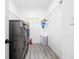 Laundry room with modern washer and dryer units, wire shelves, and hardwood flooring at 1514 Park Grove Dr, Lawrenceville, GA 30046