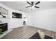 Modern living room with sleek wood floors, fireplace, and a peek into the dining area at 1514 Park Grove Dr, Lawrenceville, GA 30046