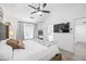 Main bedroom with a large bed, ceiling fan, and light-colored hardwood flooring at 1514 Park Grove Dr, Lawrenceville, GA 30046