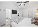 Main bedroom with a large bed, ceiling fan, and light-colored hardwood flooring at 1514 Park Grove Dr, Lawrenceville, GA 30046