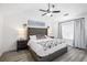 Main bedroom with a large bed, ceiling fan, and light-colored hardwood flooring at 1514 Park Grove Dr, Lawrenceville, GA 30046