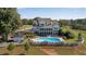 Expansive home boasts a well maintained pool area and verdant landscaping, enclosed by a white fence at 1525 Thomas Rd, Canton, GA 30115