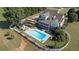 Aerial view of a beautiful home, showing the backyard pool, patio and landscaping at 1525 Thomas Rd, Canton, GA 30115