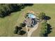A gorgeous home, in-ground pool, and winding driveway, all surrounded by beautiful landscaping at 1525 Thomas Rd, Canton, GA 30115