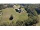 Aerial view of a large home, pool, and expansive green fields at 1525 Thomas Rd, Canton, GA 30115