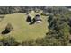 A stunning home with a pool and a sprawling green lawn surrounded by dense forest at 1525 Thomas Rd, Canton, GA 30115