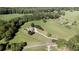 An aerial view features a stately home set on manicured grounds with an in-ground pool at 1525 Thomas Rd, Canton, GA 30115