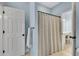 A bathroom with light blue walls, a shower featuring a patterned shower curtain, and a towel rack at 1525 Thomas Rd, Canton, GA 30115
