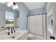 Bathroom featuring a vanity with modern fixtures and a shower/tub combination with a white shower curtain at 1525 Thomas Rd, Canton, GA 30115