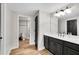 Bathroom featuring double sink, a large mirror and a door to the private toilet area for convenience at 1525 Thomas Rd, Canton, GA 30115