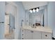 Bathroom featuring a white vanity with black fixtures, and a large framed mirror at 1525 Thomas Rd, Canton, GA 30115