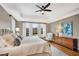 Bright bedroom with hardwood floors, a tray ceiling, and a large window with plantation shutters at 1525 Thomas Rd, Canton, GA 30115