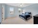 A bedroom with neutral carpet, light blue walls, and two windows with blinds allowing for natural light at 1525 Thomas Rd, Canton, GA 30115