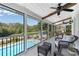 Relaxing covered patio with ceiling fans overlooks the sparkling in-ground pool and lush backyard landscaping at 1525 Thomas Rd, Canton, GA 30115