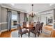 Bright dining area with hardwood floors, a chandelier, and views to a cozy living room fireplace at 1525 Thomas Rd, Canton, GA 30115