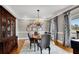 Formal dining room featuring hardwood floors, decorative curtains, and a vintage chandelier at 1525 Thomas Rd, Canton, GA 30115