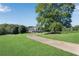 Long driveway leads to a traditional two-story home with a lush lawn and mature trees at 1525 Thomas Rd, Canton, GA 30115