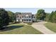 Traditional two-story home with a lush lawn and a long paved driveway at 1525 Thomas Rd, Canton, GA 30115