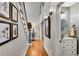 Foyer with hardwood floors, stairway, art display, and a powder room at 1525 Thomas Rd, Canton, GA 30115