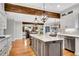 Open kitchen with granite counters, stainless appliances, an island with seating, and access to living spaces at 1525 Thomas Rd, Canton, GA 30115