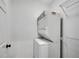 Space-saving stackable washer and dryer with wire shelving for organizing laundry essentials at 1525 Thomas Rd, Canton, GA 30115