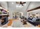 Open-concept living room with vaulted ceilings, a brick fireplace, and an attached sunroom at 1525 Thomas Rd, Canton, GA 30115
