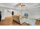Open-concept living room boasts hardwood floors, a ceiling fan, and a staircase for versatile living at 1525 Thomas Rd, Canton, GA 30115