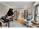 Elegant living room featuring a grand piano, French doors, and neutral decor at 1525 Thomas Rd, Canton, GA 30115