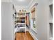Spacious walk-in pantry offering custom shelving and a window for natural light at 1525 Thomas Rd, Canton, GA 30115