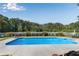 In-ground pool with manicured landscaping and mature trees at 1525 Thomas Rd, Canton, GA 30115