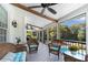 Relaxing screened porch with ceiling fans and wicker furniture overlooking the pool at 1525 Thomas Rd, Canton, GA 30115