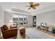 Inviting sitting area with a ceiling fan, hardwood floors, natural light and cozy furnishings for relaxation at 1525 Thomas Rd, Canton, GA 30115