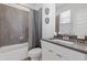 Tiled bathroom featuring a shower/tub combination, modern vanity, and stylish decor at 1756 Morningtide Ne Ln, Atlanta, GA 30324