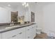 Modern bathroom featuring double vanity with white cabinets, dark countertop, and glass-enclosed shower at 1756 Morningtide Ne Ln, Atlanta, GA 30324