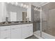 Modern bathroom featuring double vanity, stylish lighting, and glass-enclosed shower at 1756 Morningtide Ne Ln, Atlanta, GA 30324