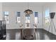 Dining room with hardwood floors, modern light fixture, and large windows for natural light at 1756 Morningtide Ne Ln, Atlanta, GA 30324